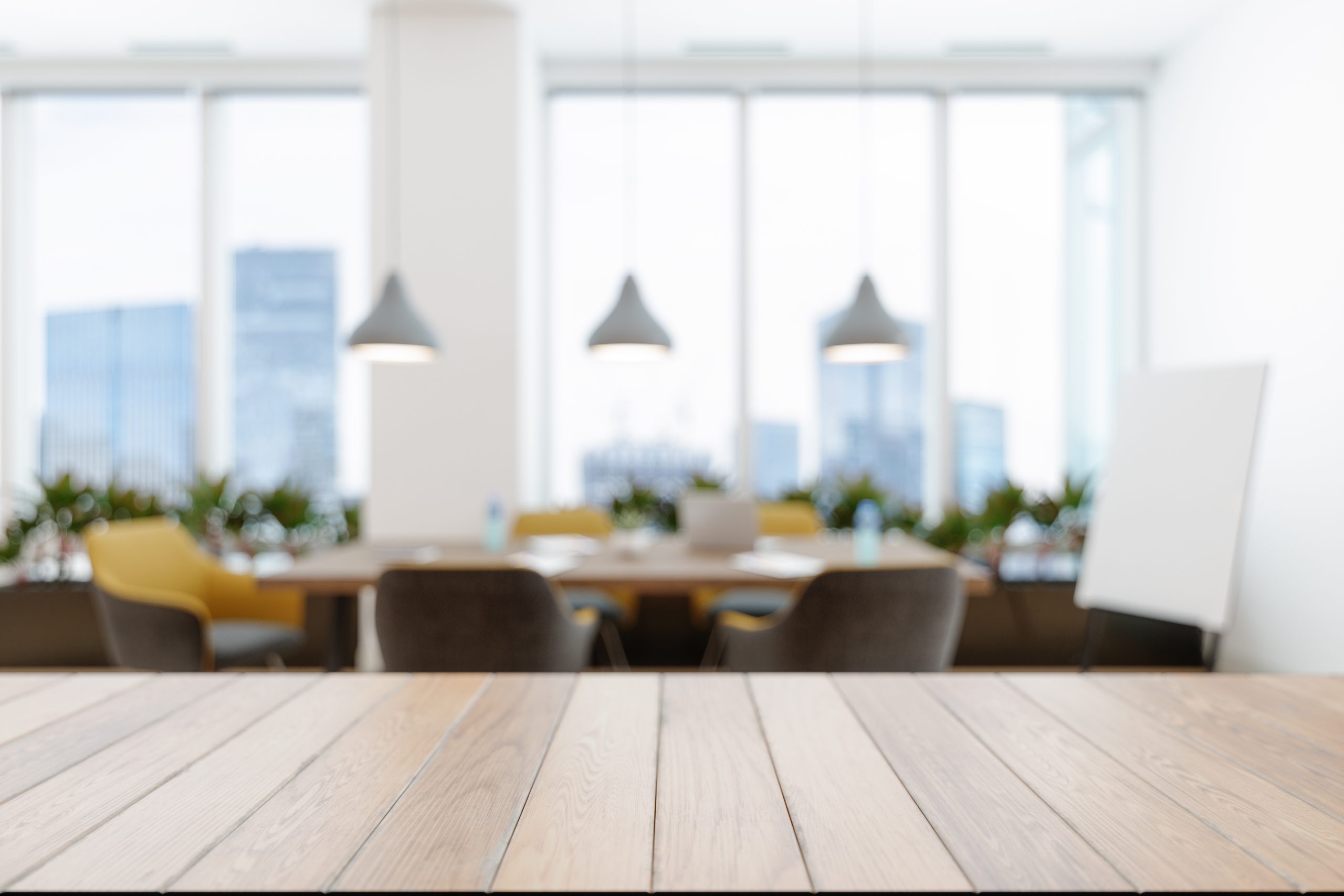 Wood Empty Surface And Abstract Blur Meeting Room With Conference Table, Yellow Chairs And Plants.